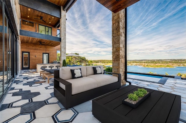 view of patio featuring a water view and outdoor lounge area