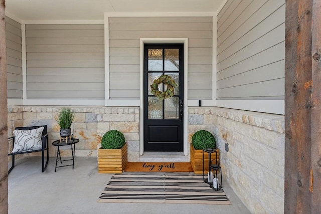 property entrance with stone siding