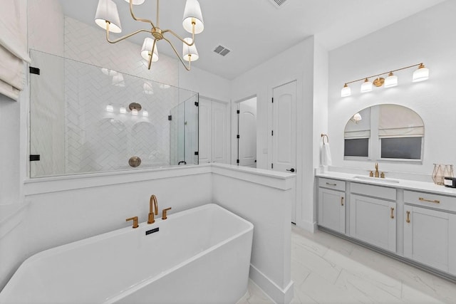 bathroom featuring marble finish floor, visible vents, a freestanding bath, a chandelier, and tiled shower