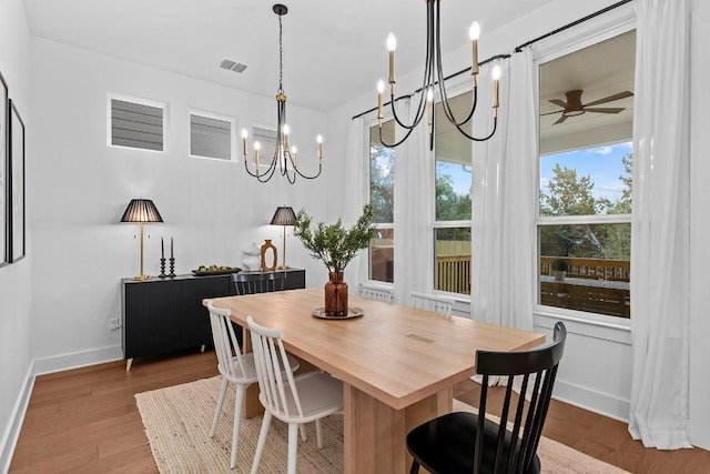 dining room featuring a ceiling fan, baseboards, visible vents, and wood finished floors