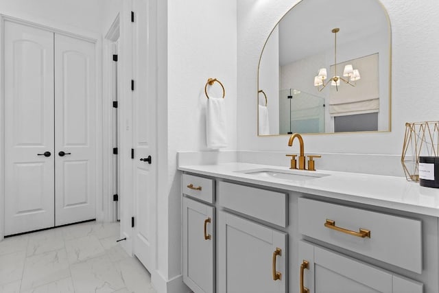 bathroom featuring vanity and a chandelier