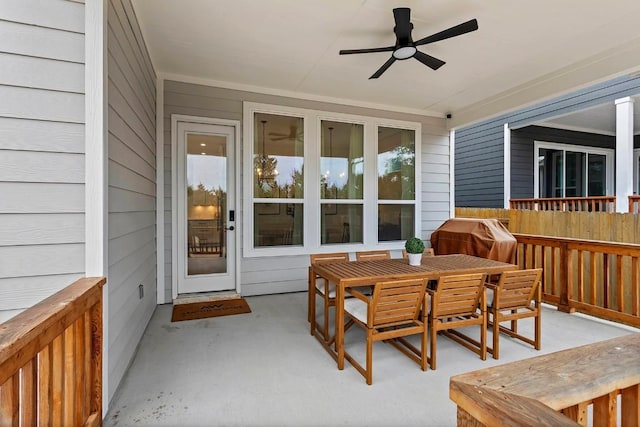 exterior space with a patio, grilling area, a ceiling fan, and outdoor dining space