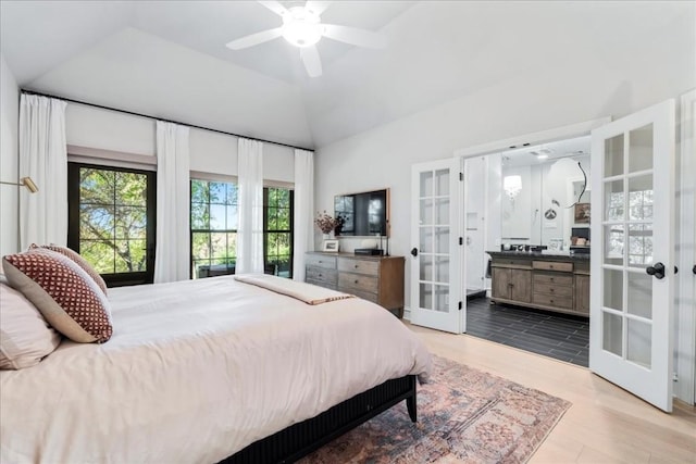 bedroom featuring light hardwood / wood-style flooring, vaulted ceiling, french doors, and ceiling fan