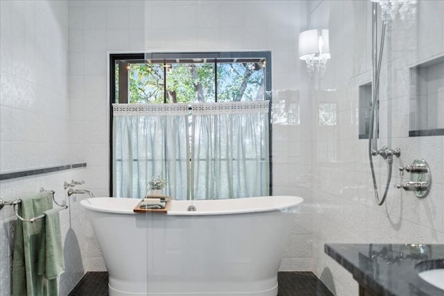 bathroom featuring tile walls and a tub to relax in