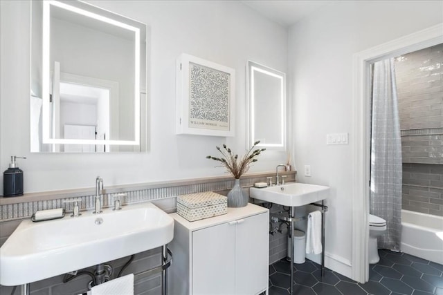 full bathroom featuring shower / tub combo with curtain, tile patterned floors, toilet, and sink