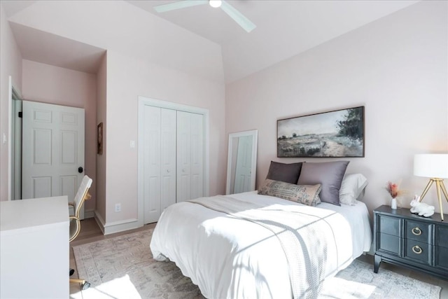 bedroom featuring light wood-type flooring, ceiling fan, and a closet