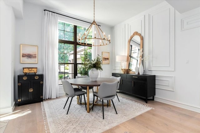 dining room featuring an inviting chandelier and light wood-type flooring