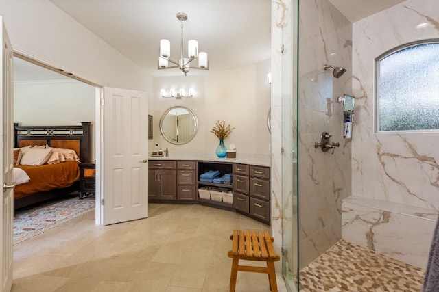 bathroom with vanity, lofted ceiling, a tile shower, and an inviting chandelier