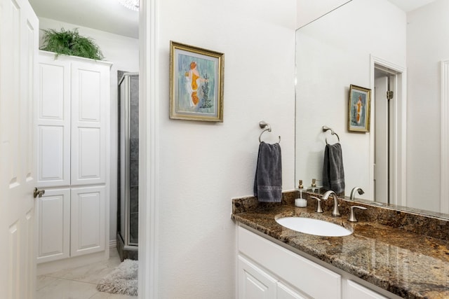 bathroom with vanity and a shower with shower door