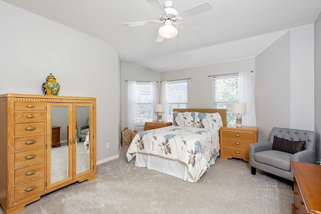 bedroom featuring lofted ceiling, carpet floors, multiple windows, and ceiling fan