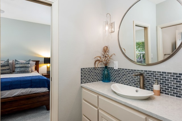 bathroom featuring vanity and decorative backsplash