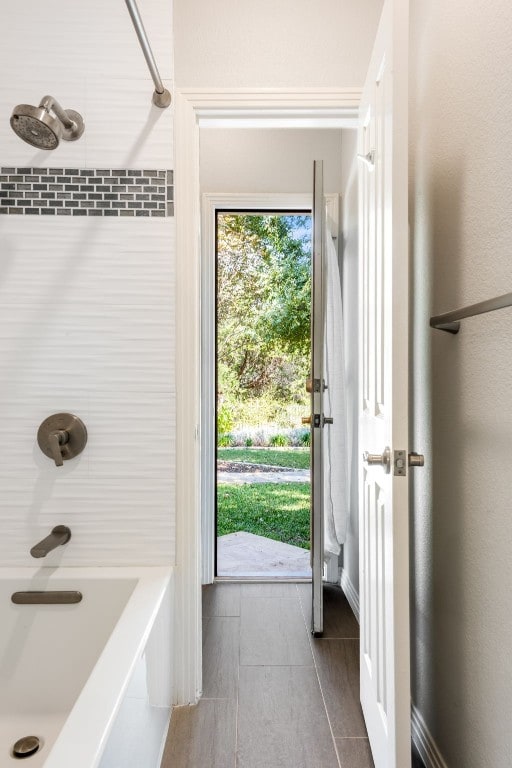 bathroom with bathing tub / shower combination