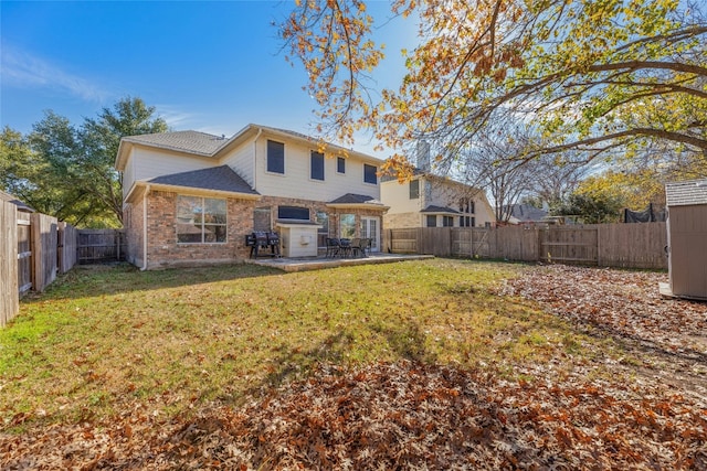 back of property with a patio and a lawn