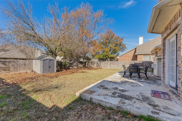 view of yard with a storage shed and a patio area