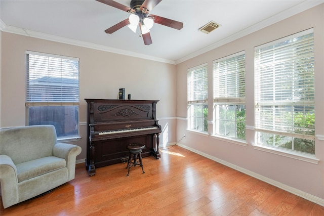 sitting room with ceiling fan, ornamental molding, and light hardwood / wood-style flooring