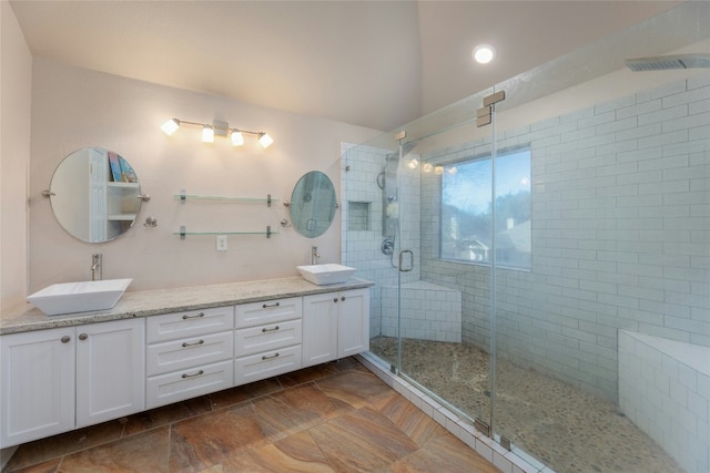 16805 Willow Oak Ln, Round Rock, TX 78681 - full bathroom featuring double vanity, a shower stall, and stone finish flooring