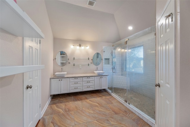 bathroom with lofted ceiling, vanity, and walk in shower