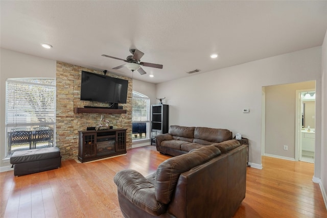 living room featuring ceiling fan and light wood-type flooring