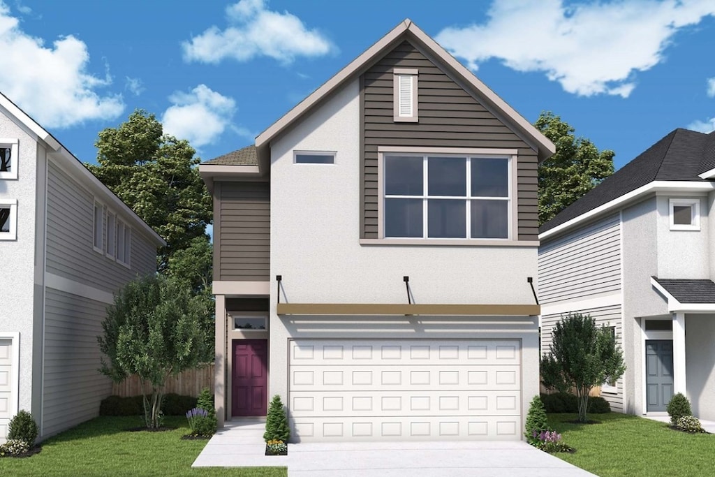 view of front of home featuring a garage and a front lawn