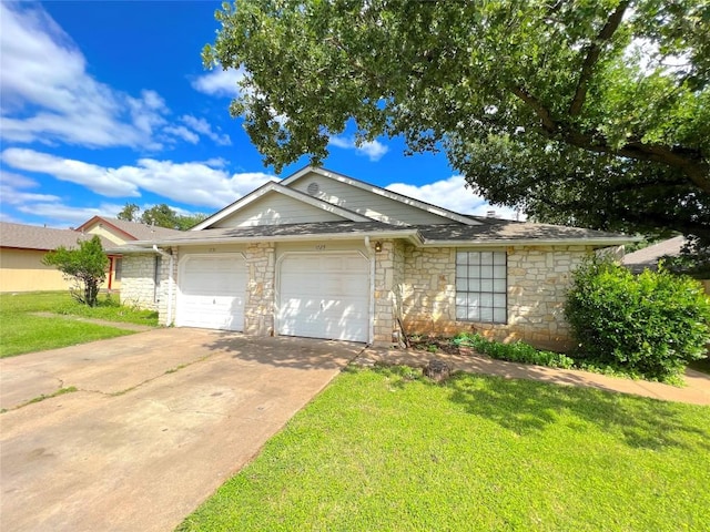 ranch-style home with a garage and a front yard