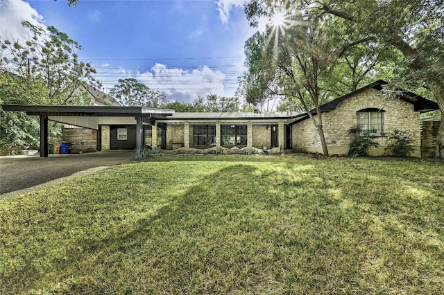 view of front of house with a front lawn and a carport