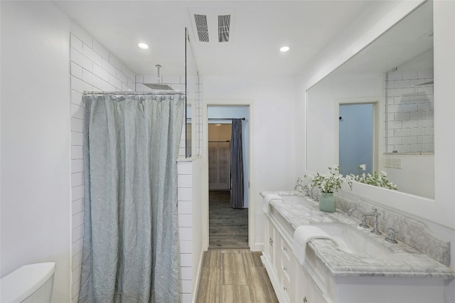 bathroom with hardwood / wood-style flooring, vanity, toilet, and a shower with shower curtain