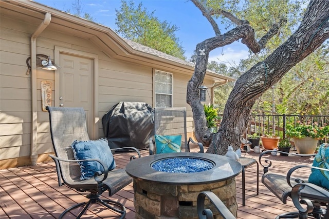 deck featuring a grill and a fire pit