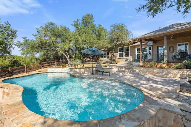 view of swimming pool featuring ceiling fan and a patio