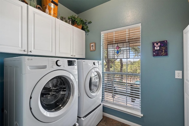 laundry room with washer and dryer and cabinets