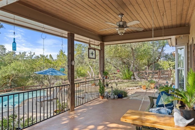 sunroom / solarium with wooden ceiling and ceiling fan