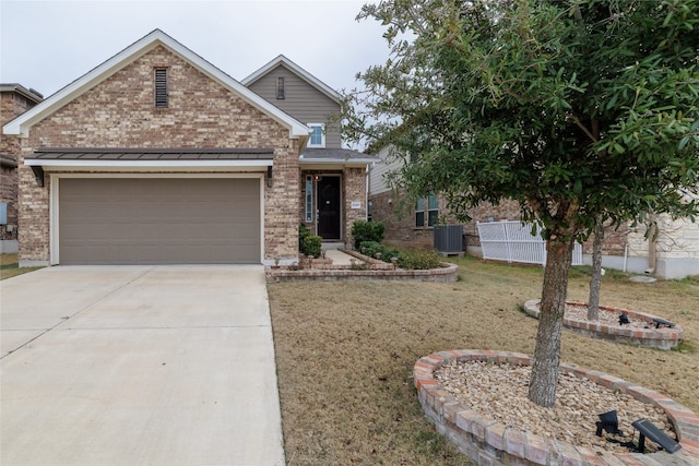 view of front of home featuring central AC unit, a garage, and a front yard