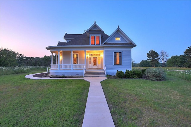 view of front of house with a yard and covered porch