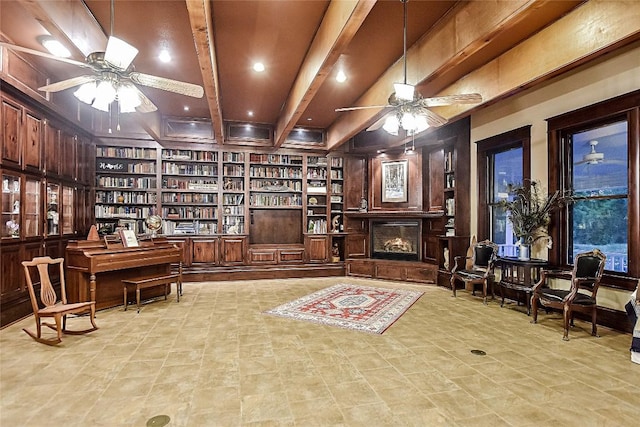 sitting room featuring beamed ceiling, ceiling fan, and built in features