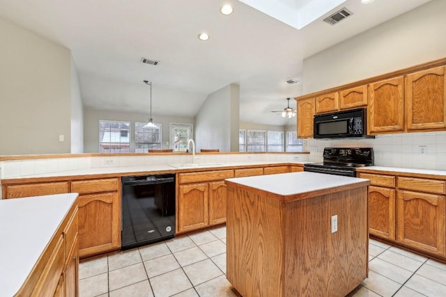 kitchen with sink, a center island, hanging light fixtures, decorative backsplash, and black appliances