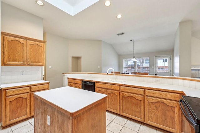 kitchen with decorative light fixtures, sink, backsplash, a center island, and black appliances