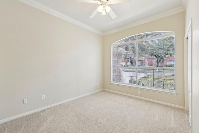 unfurnished room featuring ornamental molding, a wealth of natural light, and light carpet