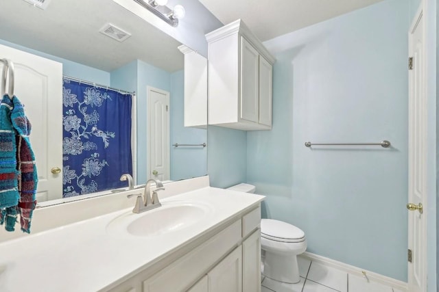 bathroom featuring tile patterned flooring, vanity, and toilet