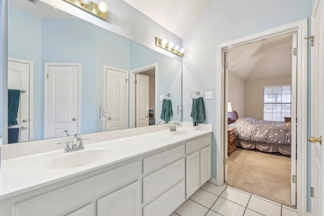 bathroom featuring tile patterned floors, lofted ceiling, and vanity