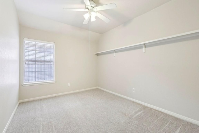 spare room featuring ceiling fan and carpet flooring