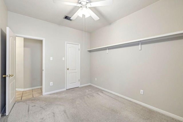 unfurnished bedroom with ceiling fan and light colored carpet