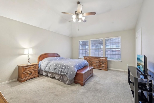 bedroom with ceiling fan, vaulted ceiling, and light carpet