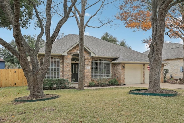 single story home featuring a garage and a front yard