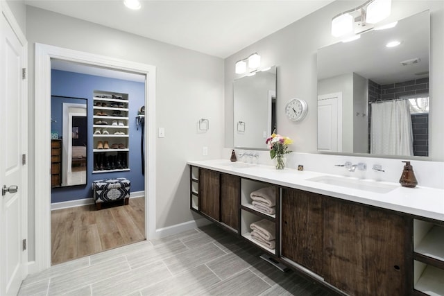 bathroom featuring vanity and curtained shower