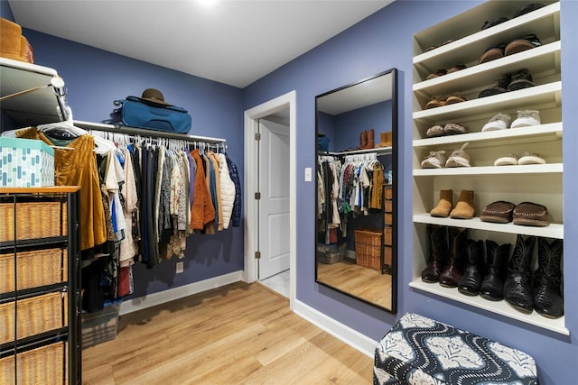 walk in closet featuring light hardwood / wood-style flooring