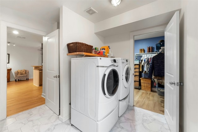 washroom with washing machine and clothes dryer