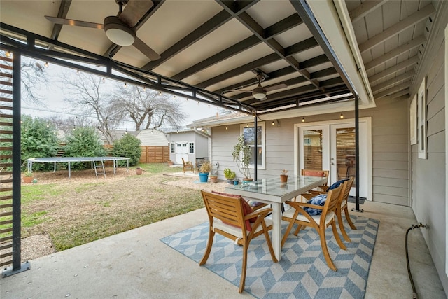 view of patio featuring a trampoline, french doors, and ceiling fan