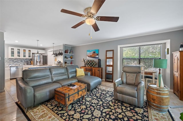 living room featuring crown molding, ceiling fan, and light tile patterned flooring