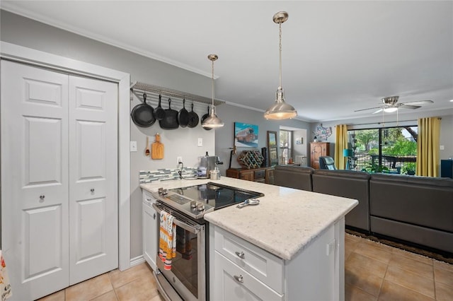 kitchen featuring stainless steel electric range, light stone counters, white cabinets, decorative light fixtures, and kitchen peninsula