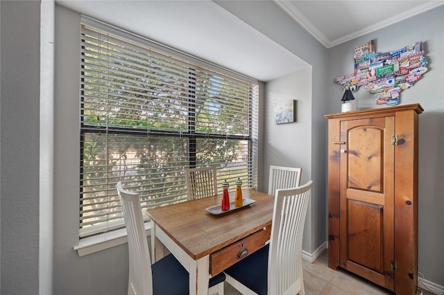 dining space featuring crown molding and light tile patterned floors