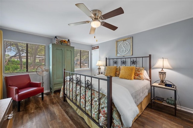 bedroom featuring dark wood-type flooring, ornamental molding, and multiple windows